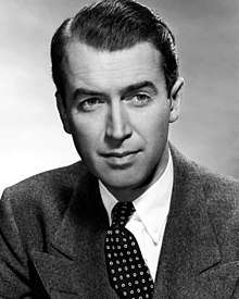 Black and white photo of James Stewart in 1948—an elegant white man with arched eyebrows and short, smooth hair combed to the side, around 40 years old.