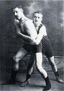 Two young men wrestling