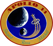The circular patch depits the Earth and the Moon. An astronaut lapel pin leaves a comet trail from the liftoff point on Earth. Around it is the logo "Apollo 14 – Shepard Roosa Mitchell"