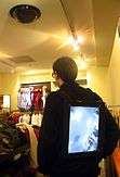 Back view showing the man facing away.  Here we see the backwards facing video display on the jacket.