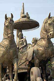 Photograph of a bronze chariot. The discourse of Krishna and Arjuna in Kurukshetra is the Bhagavad Gita.
