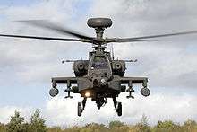 Front-end view of attack helicopter taking off