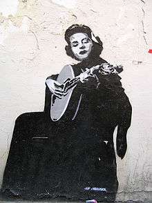 Mural of a seated Amália Rodrigues playing a lute-like instrument
