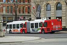 Red-and-white articulated bus
