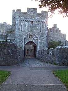the gateway to the castle through a tower with portcullis