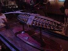 A large model of a mechanical submarine perched atop a flat table mount.