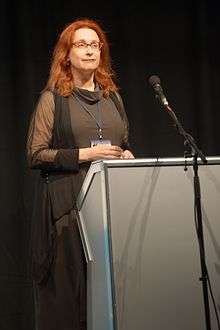 Photograph of Audrey Niffenegger standing behind a lectern, delivering the inaugural PEN/H.G. Wells lecture at Loncon, Worldcon 2014