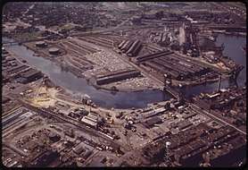 Color image of a heavy industrial district abutting a winding river