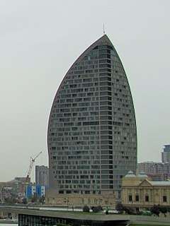 A photograph showing the Trump International Hotel and Tower building in Baku, which is shaped like a sail.