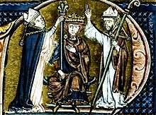 Two bishops puts a crown on the head of a man who sits on a throne