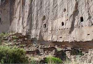 A Remains of multistory dwelling built into volcanic tuff wall, Bandelier National Monument, New Mexico