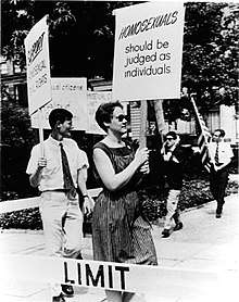 Annual Reminder picket at Independence Hall in Philadelphia, 1966; photo by Kay Tobin Lahusen. The woman with the sign saying "HOMOSEXUALS should be judged as individuals" is Barbara Gittings.