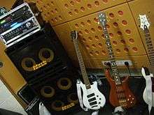 A bass stack has two speaker cabinets (one with four ten-inch loudspeakers and one with two ten-inch loudspeakers). On top of the stacked speaker cabinets is a bass amplifier unit.