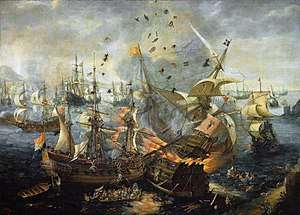 Painting of a fleet of ships showing one ship exploding in flames, with men and debris flying in the air and other men in the water, jumping overboard or taking to lifeboats