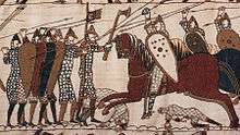 A scene from the Bayeux Tapestry depicting mounted knights attacking footsoldiers