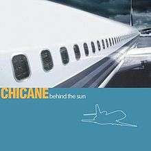 The album cover for Behind the Sun. The cover portrays a close up shot of the side of an aeroplane in the top half. The lower half is solid light blue with the artist and album name written on it in yellow and white respectively.