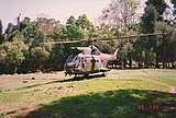 A large helicopter in a jungle clearing