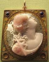 Pink and white stone cameo of a woman looking up and to the right