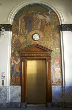 Mural and wood work surrounding the elevator