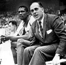 Bill Russell and Red Auerbach watching a game from the bench