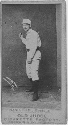 A black-and-white baseball card image of a mustachioed man wearing a white old-style baseball uniform and cap