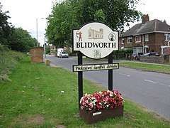 Sign saying Blidworth welcomes careful drivers, with images of Robin Hood, the church and a coal mine