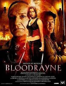 Bloodrayne stands centre, shown holding her special blades. The face of Kagan fills the frame behind her on the left, on her right Vladimir holds his sword ready for action.