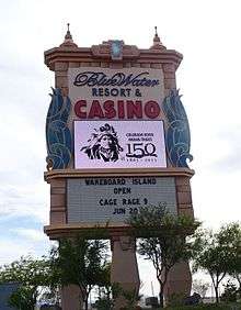 A color picture of the entry to the Bluewater Resort and Casino, with a sign celebrating the 150th anniversary of the reservation. The logo includes a black and white image of Irataba.