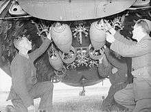 Armourers secure 250lb bombs in the bomb-bay of a Lockheed Hudson of No. 224 Squadron at Leuchars.