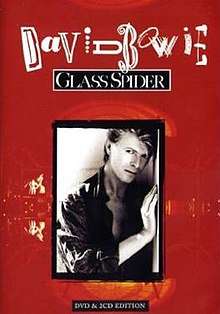 A contemporary picture of David Bowie leaning against a wall, set in a frame inside a red background with the title "David Bowie Glass Spider" above it