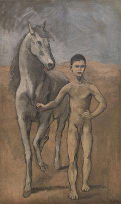 A picture of a young man outdoors, leading a horses.