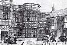 Engraved picture of the courtyard with people in 17th century costume and horses.