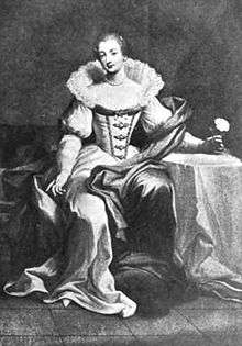 An image of Bridget Paston, Edward Coke's first wife. She is sat next to a table covered in white cloth, on which she rests her arm, and is wearing a white dress with a corset, a long skirt and a wide ruff around the neck and shoulders.