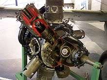 A Bristol Perseus air-cooled radial aircraft engine, with sleeve-valves. The engine has been sectioned for display. One of the upper cylinders has been sectioned, showing inside the cylinder and cutting into the junk head.