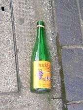 An empty bottle of Buckfast discarded in the street.