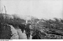 Photograph of I Battalion leaving the burning village of Gornji Turki, 5 April 1944