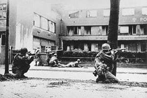 Soldiers hide along streets during an urban battle