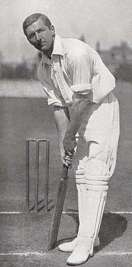 A cricketer in his batting stance.