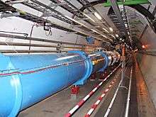 Image of the CERN Large Hadron Collider featuring the main pipe and tracks for transports.