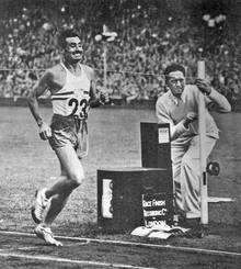 A black and white photo of a track athlete wearing the number 23 running.