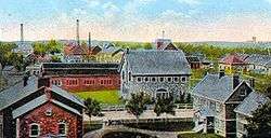 Postcard of the Calumet and Hecla company town, showing multiple buildings.