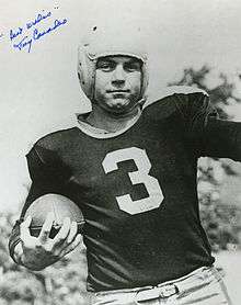 An autographed photo of Tony Canadeo holding a football