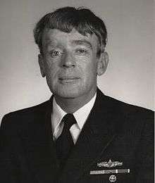 A black and white image showing Kelley from the waist up in his military dress uniform.