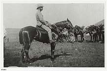Officer with sun helmet on horseback