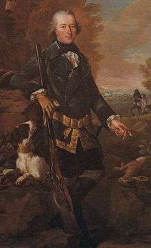 Full length portrait of a man in a dark coat holding a rifle about four and a half feet long with his dog