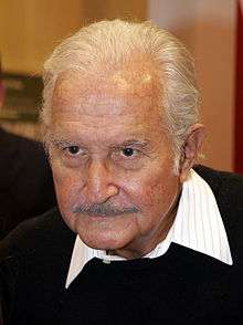 Head photo of a greying man with a small moustache.