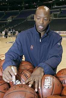 A basketball player is signing a basketball