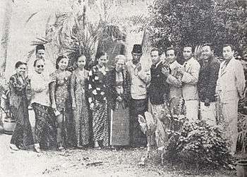 A group photograph of 13 men and women