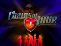 The words "Chains of Love" appear in front of the silhouettes of five figures and a CGI-model of a man wearing dark sunglasses