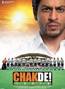 Theatrical release poster depicts coach Kabir Khan, looking over the  bad Indian Women's National Field Hockey Team. Text at the bottom of the poster provides the title, tagline, production credits and release date.